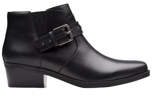 A black leather ankle boot with a low block heel and an adjustable strap across the side featuring a silver buckle.