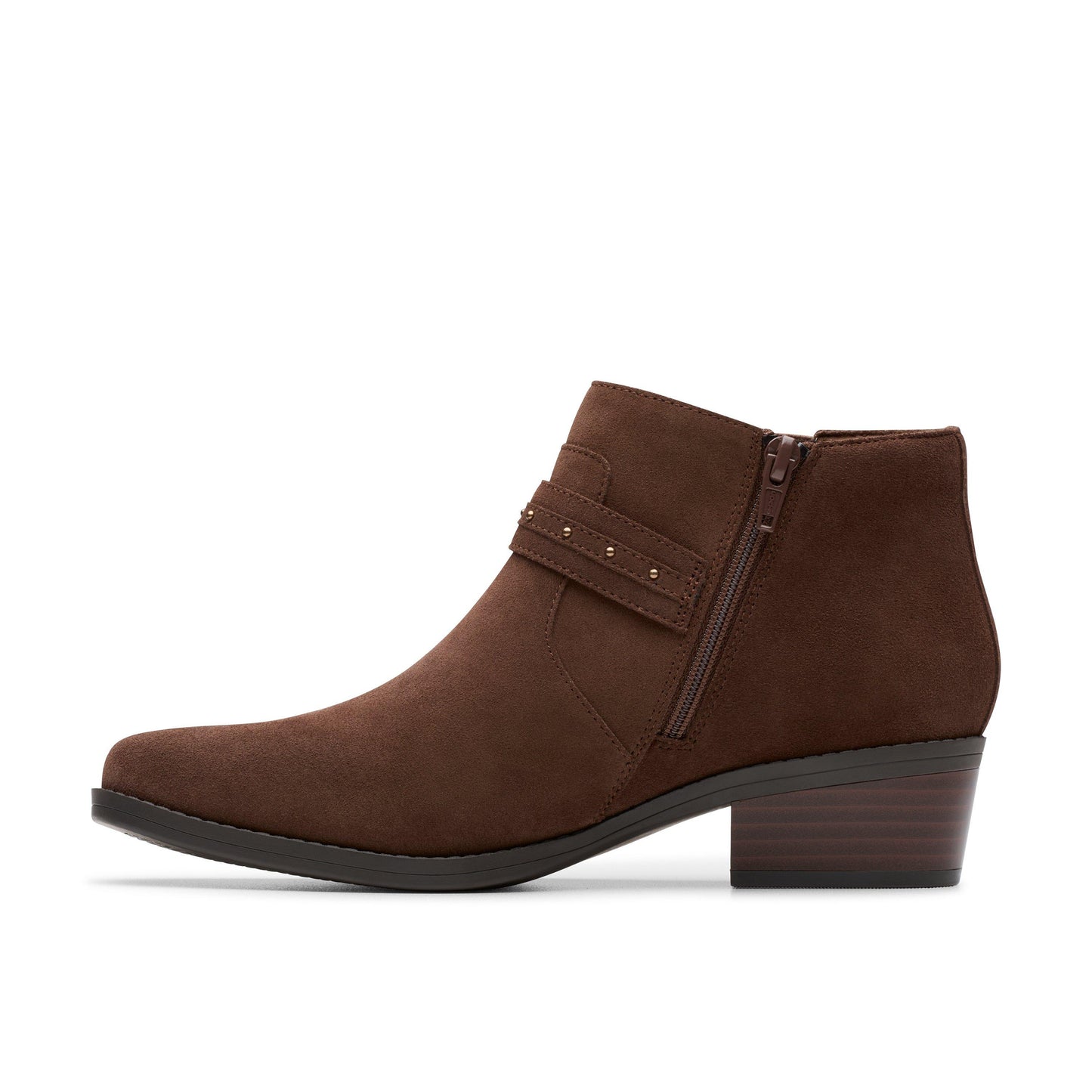 A brown ankle boot with a short block heel and a decorative strap with studs.