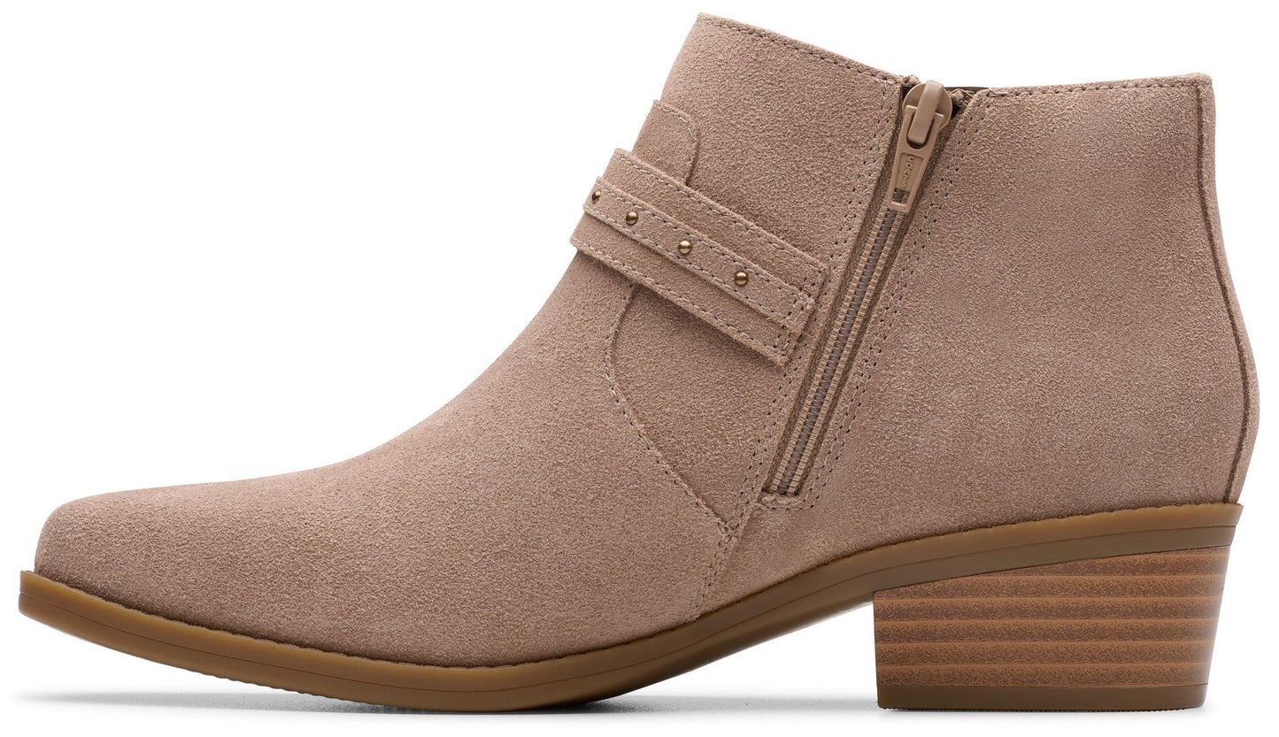 Side view of taupe ankle boot with side zipper and decorative strap with rivets