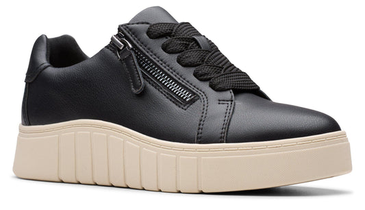 Black leather sneaker with black laces and a tan sole, and a decorative zipper on the side.