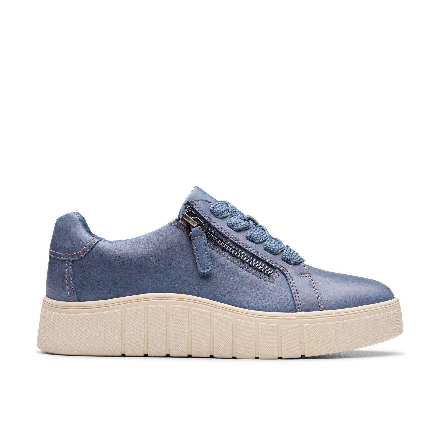A blue leather sneaker with a zip closure, decorative laces, and a thick beige sole.