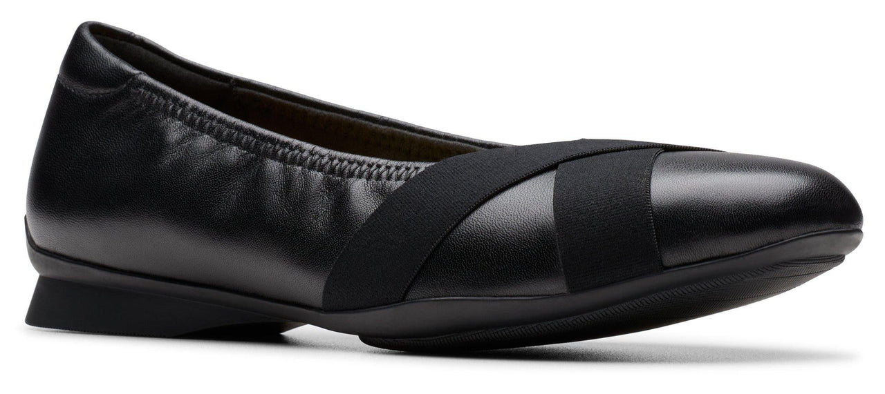 Black ballet flat with crossed elastic straps.