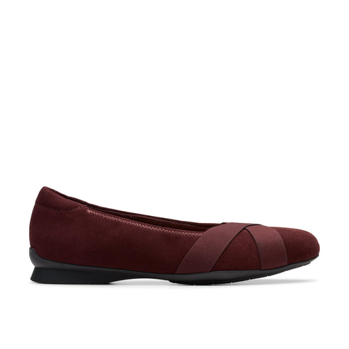 Maroon ballet flat shoe with crossing straps.