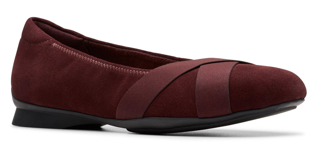 A burgundy ballet flat with criss-cross elastic straps.