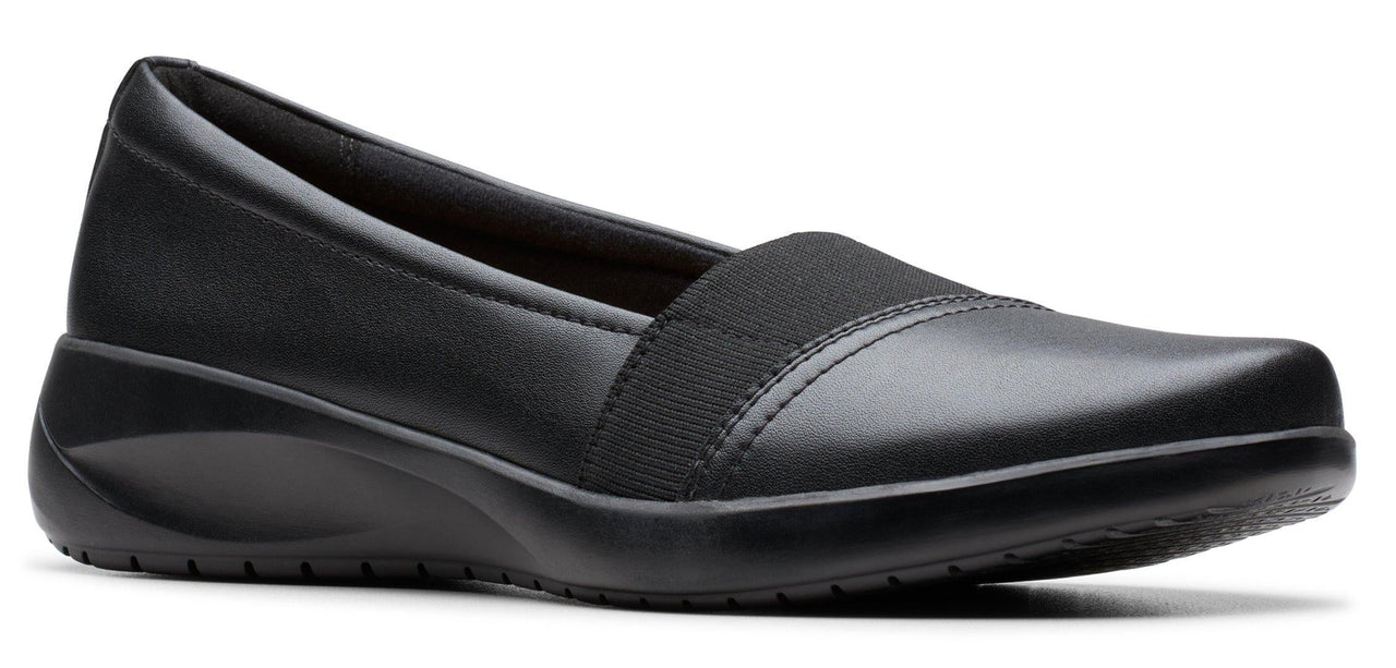 Black slip-on shoe with a low wedge heel.