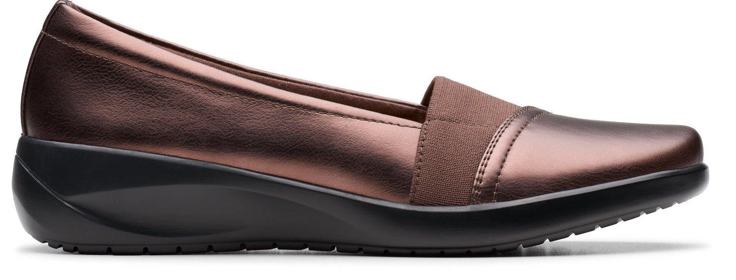 Bronze slip-on shoe with a wedge heel.