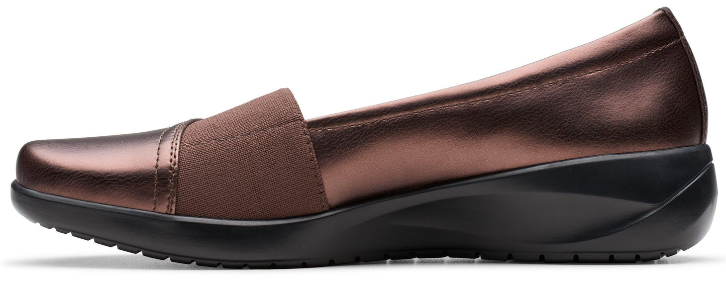 Brown slip-on shoe with a low wedge heel and elastic band.