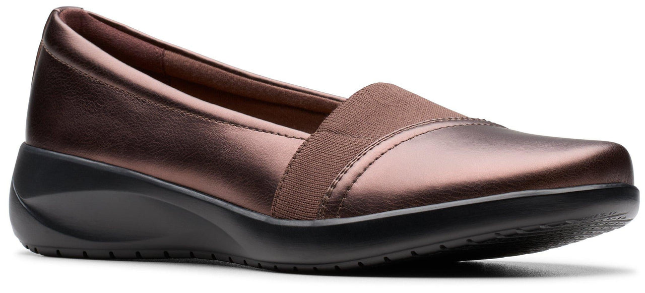 A brown slip-on shoe with a wedge heel.