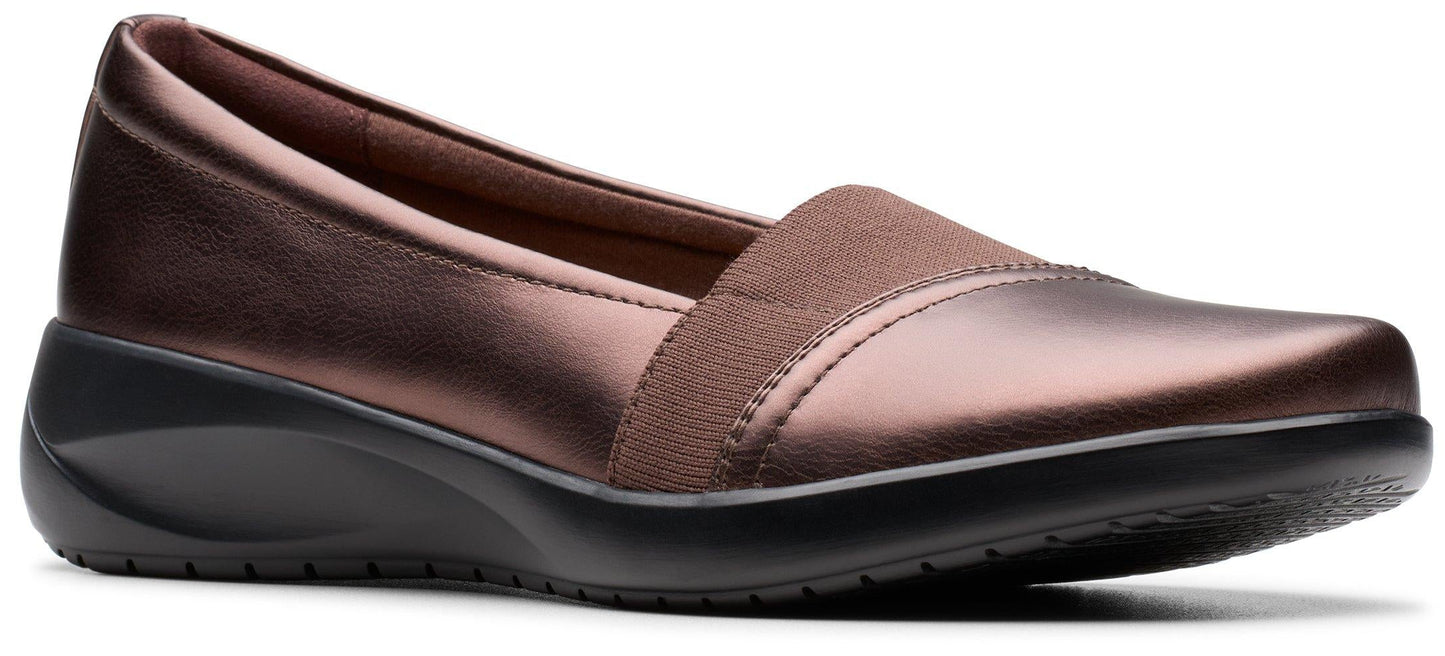 A brown slip-on shoe with a wedge heel.