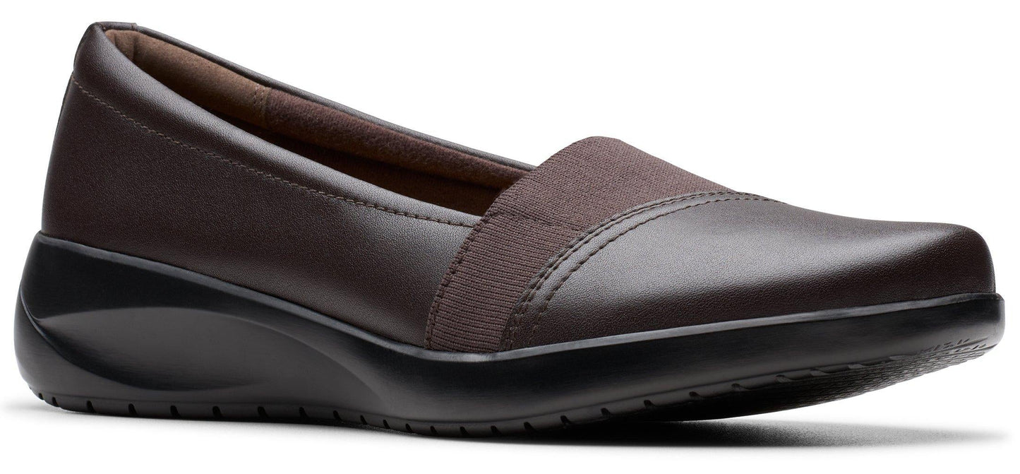 A brown slip-on wedge shoe.