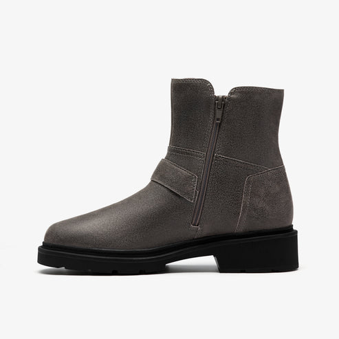 A gray ankle boot with a low, black, flat heel and a side zipper.
