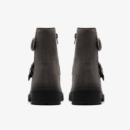 A pair of gray suede ankle boots with black lug soles and adjustable buckle straps.