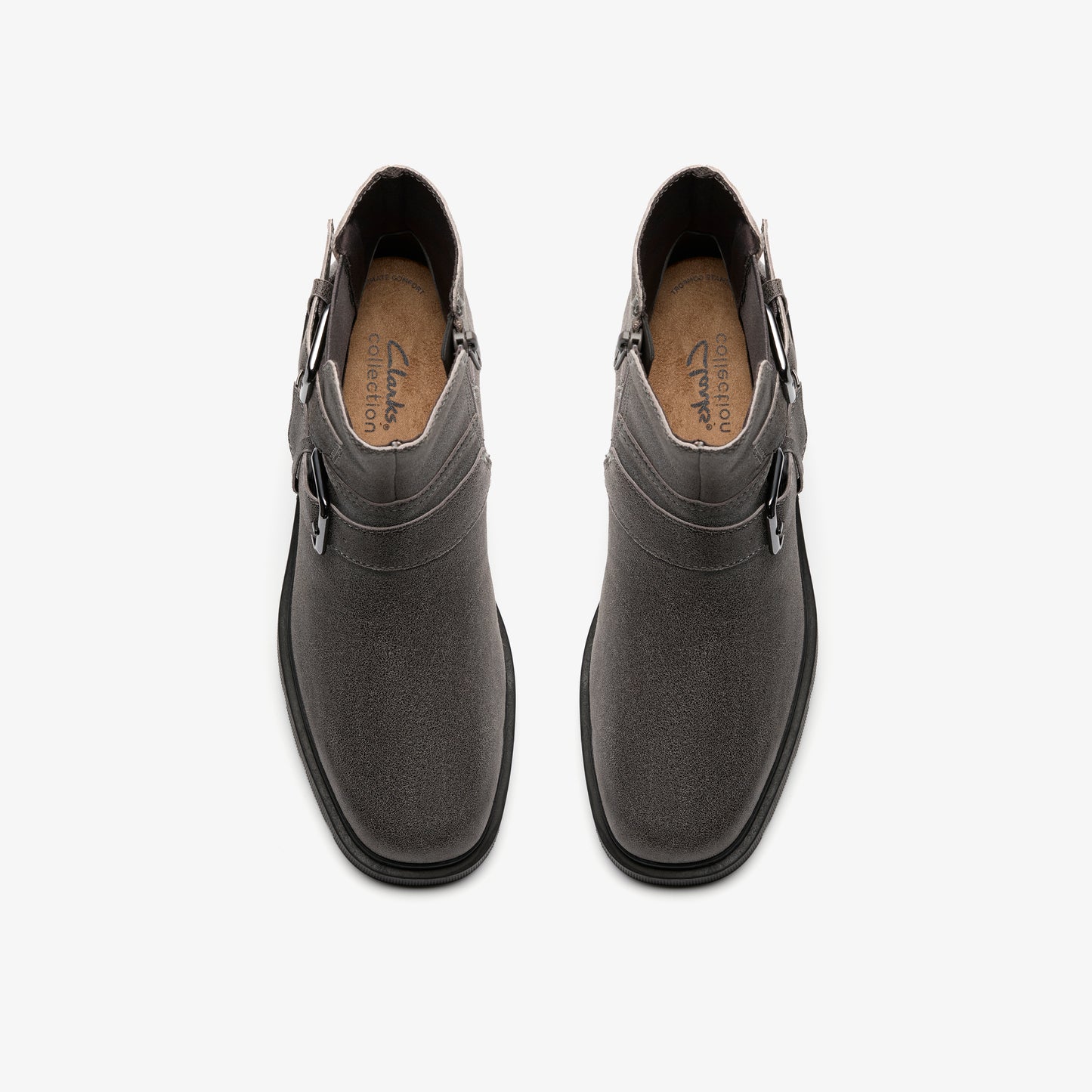 Pair of gray ankle boots with buckle accents, viewed from above.