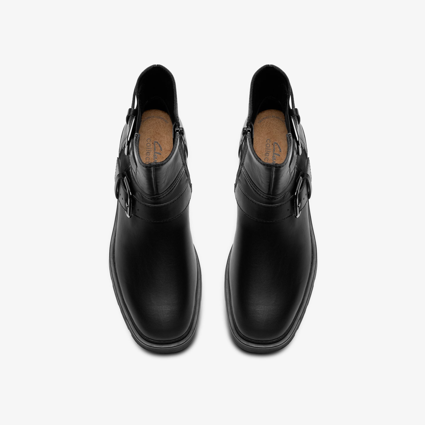 A pair of black leather ankle boots, featuring a rounded toe, a side zipper, and buckle straps.