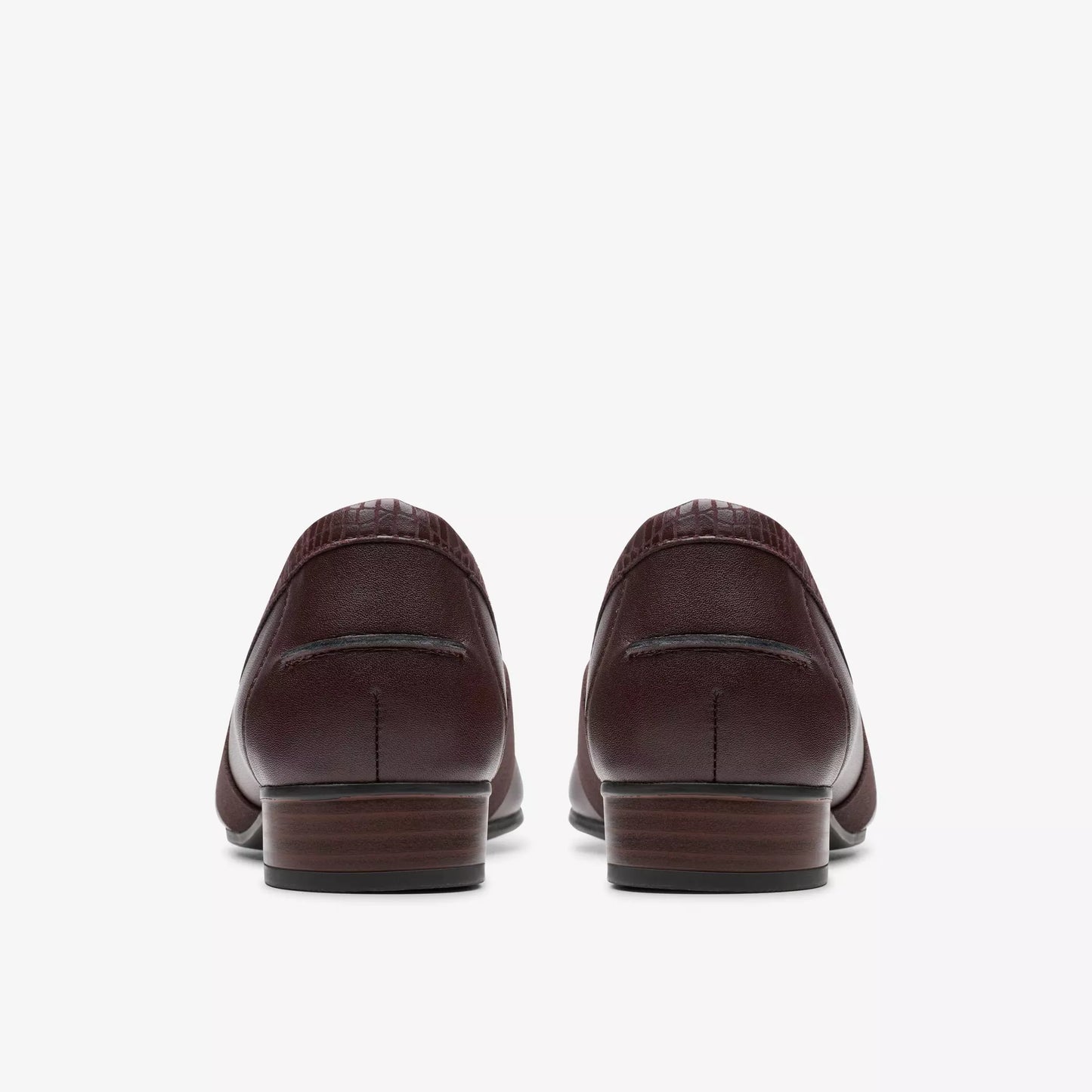 Back view of a pair of maroon leather loafers with dark outsoles.