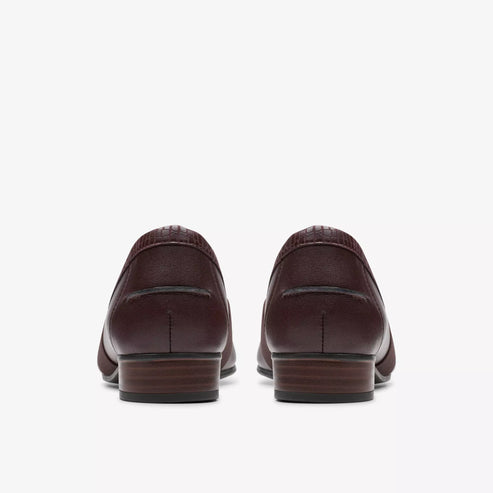 Back view of a pair of maroon leather loafers with dark outsoles.