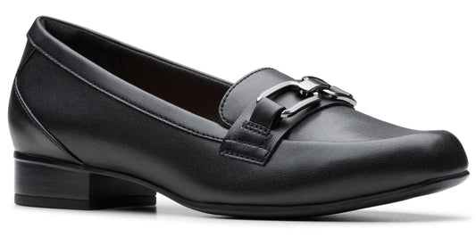 A black leather loafer with a square toe and a metallic accent on the top.