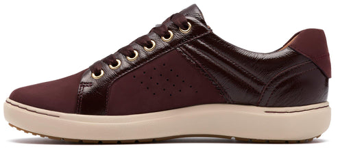 Burgundy sneaker with a tan sole and gold eyelets.