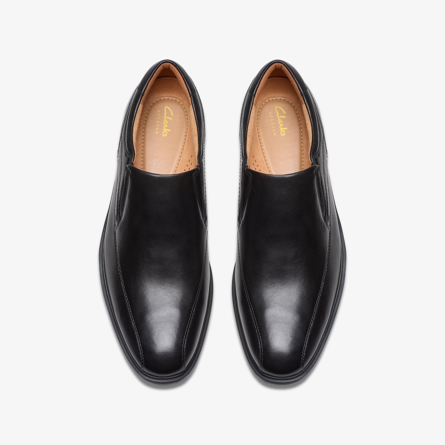 Top-down shot of black leather dress shoes with rounded toe.