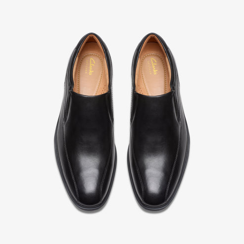 Top-down shot of black leather dress shoes with rounded toe.