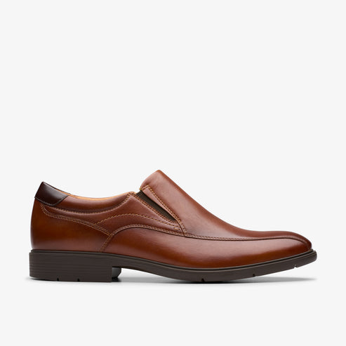 A brown, leather slip-on dress shoe.
