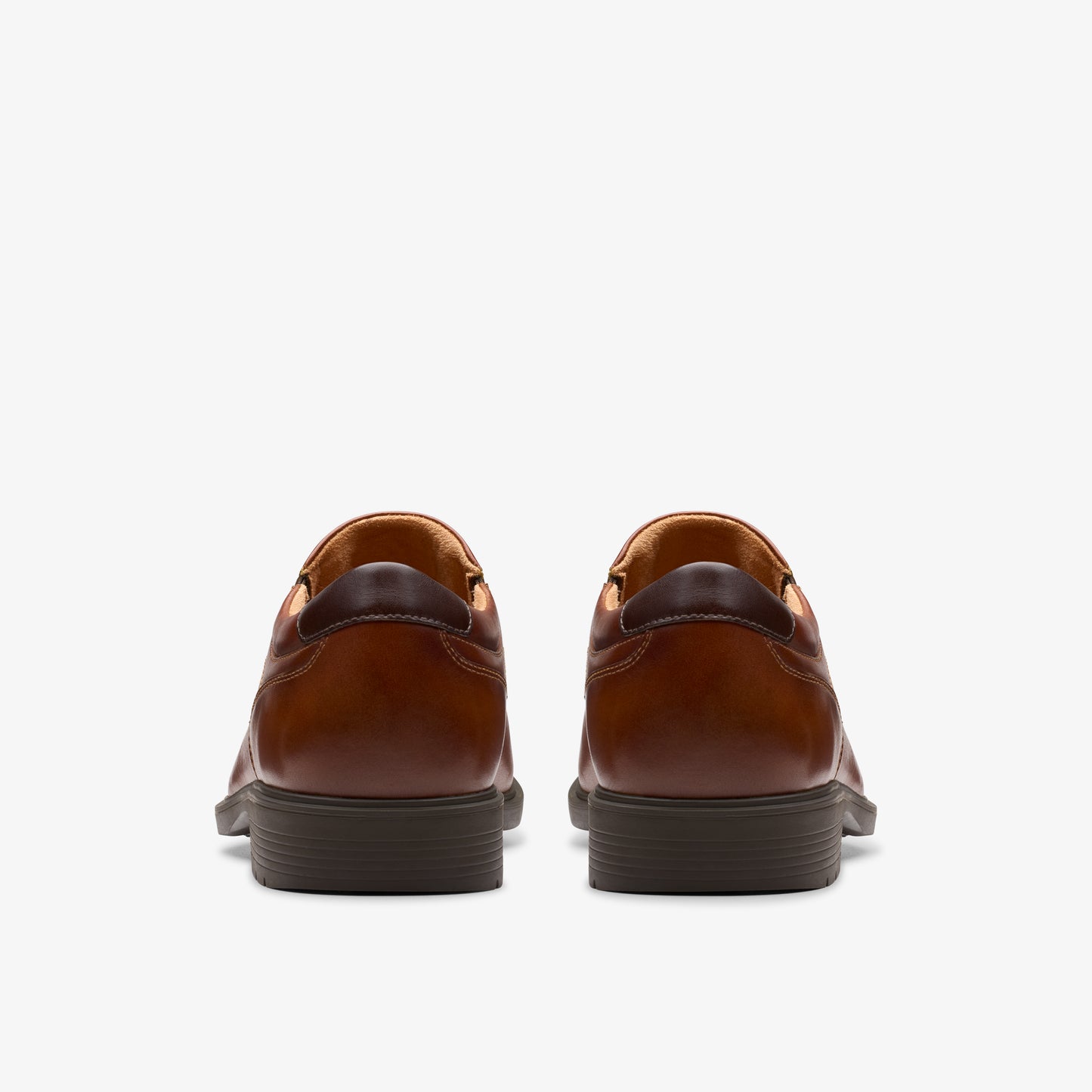 Pair of brown leather dress shoes, rear view.