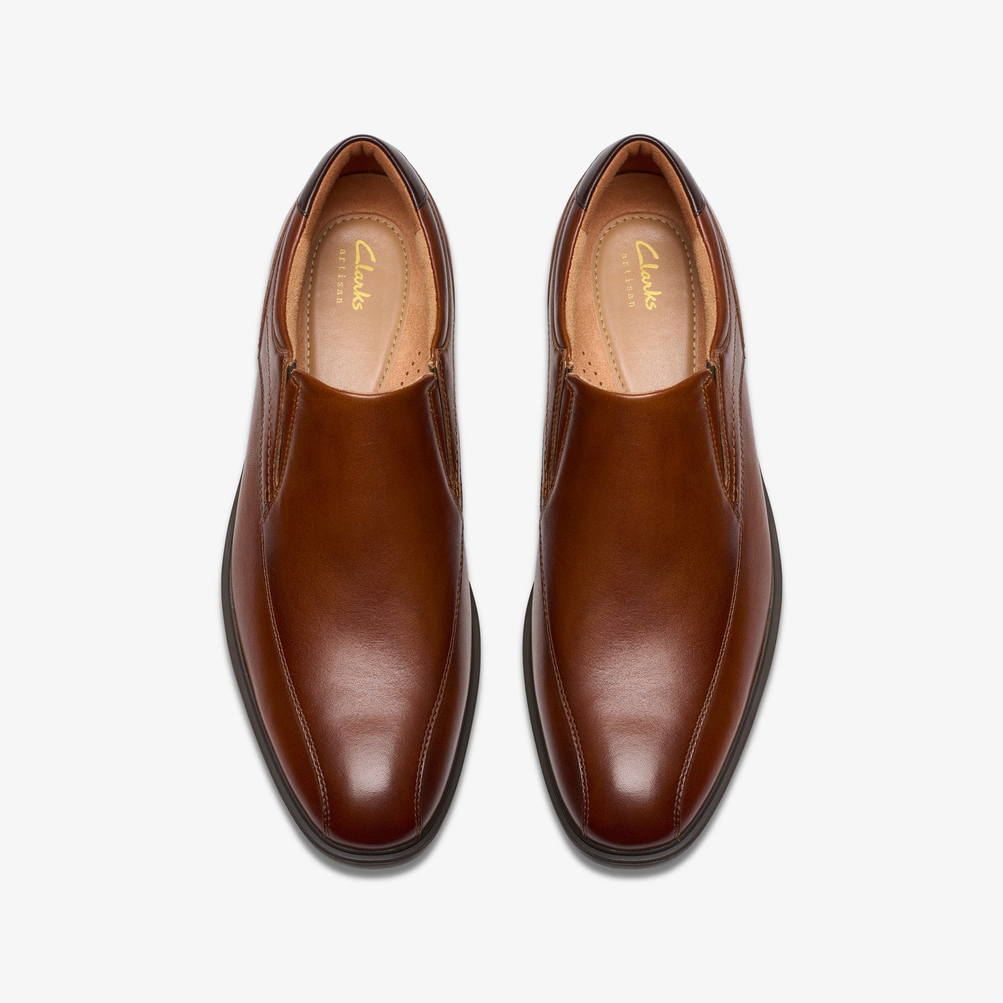 Pair of brown leather slip-on dress shoes with rounded toes.