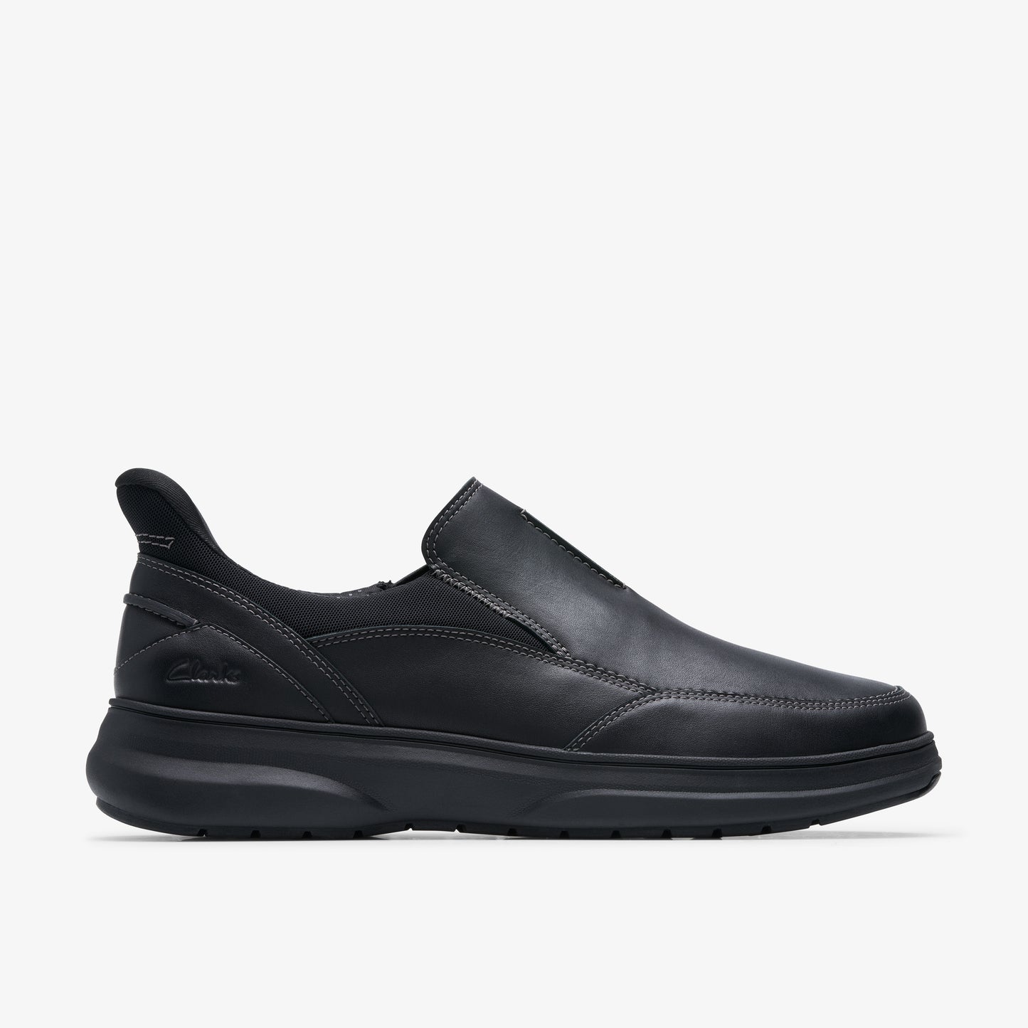 Black slip-on shoe with a low profile and a thick sole.