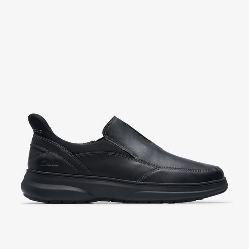 Black slip-on shoe with a low profile and a thick sole.