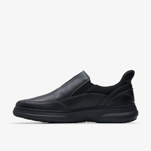 A black leather slip-on shoe with a rounded toe and a thick sole.