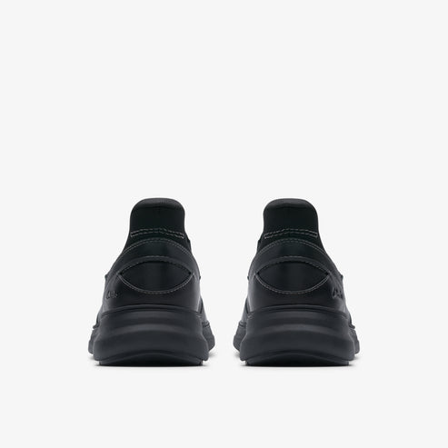 Rear view of two black running shoes with thick black soles.