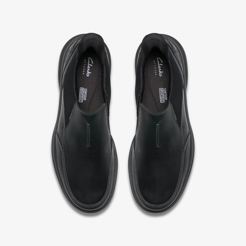 Overhead view of two black slip-on shoes with visible "Clarks" logo.