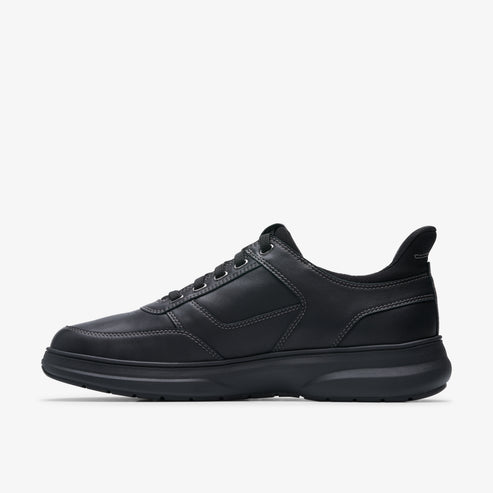 Black leather sneaker with tonal stitching and dark sole.