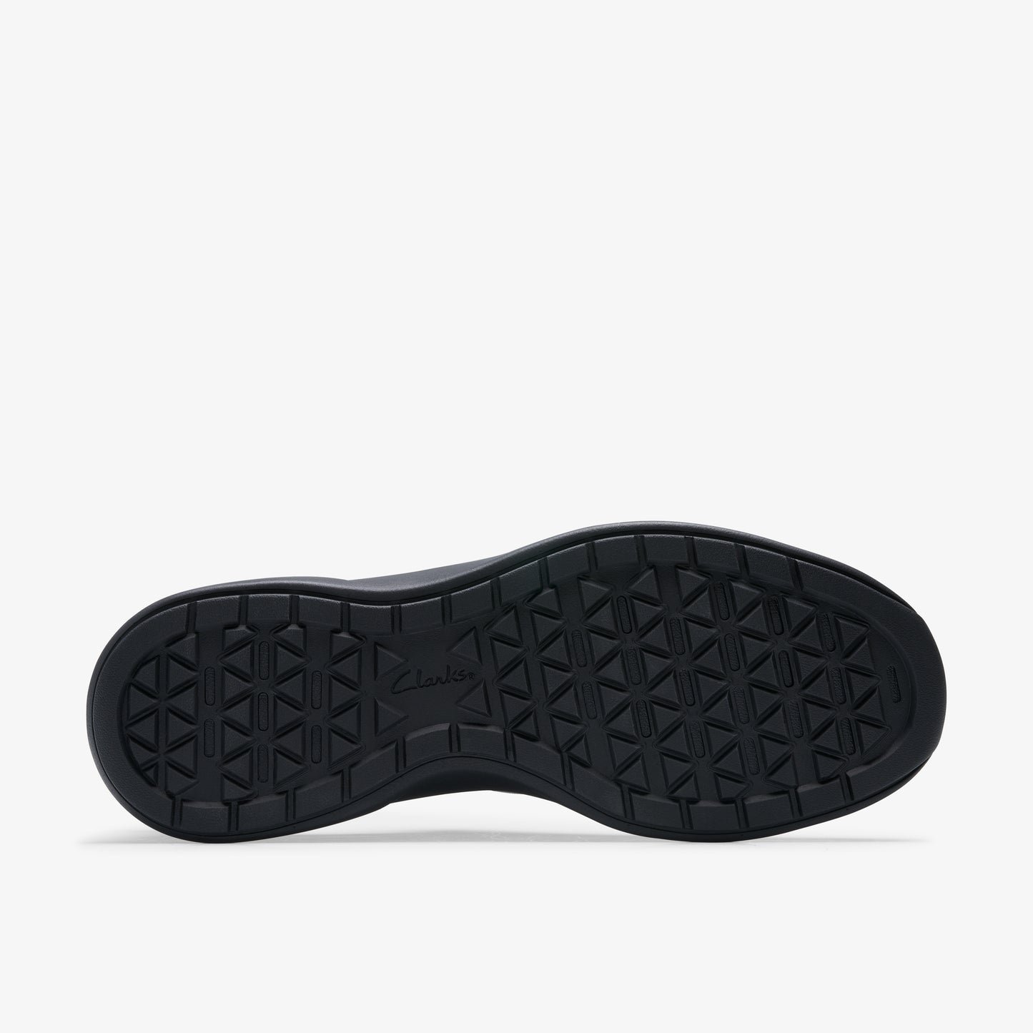 The black rubber outsole of a shoe features a repeating pattern of small triangles.