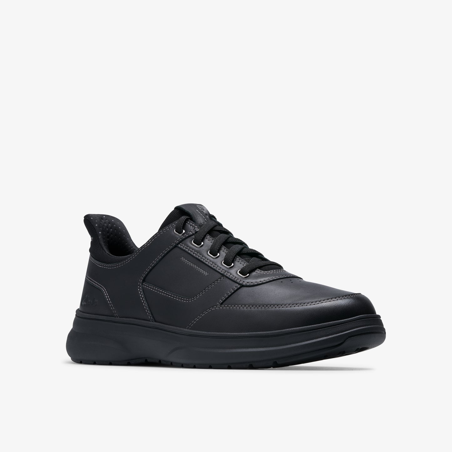 A black leather sneaker with black laces and a thick, black sole.