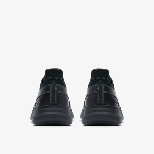 Back view of a pair of black leather shoes with a thick sole.