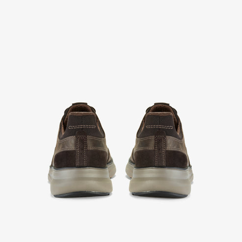 Rear view of a pair of brown suede casual shoes with decorative stitching and thick, translucent soles.