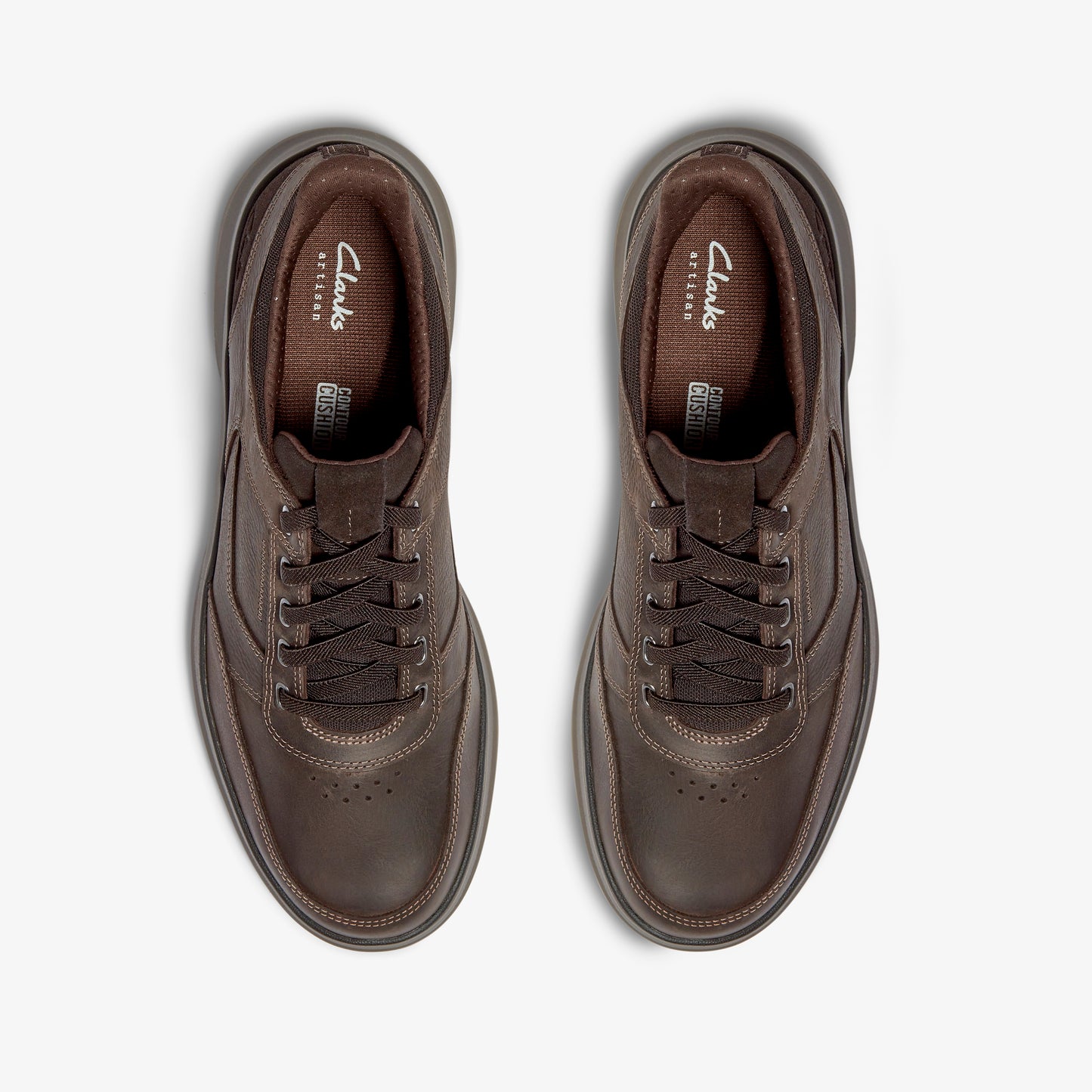 Pair of brown leather sneakers with laces, seen from above.