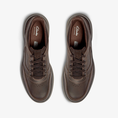 Pair of brown leather sneakers with laces, seen from above.