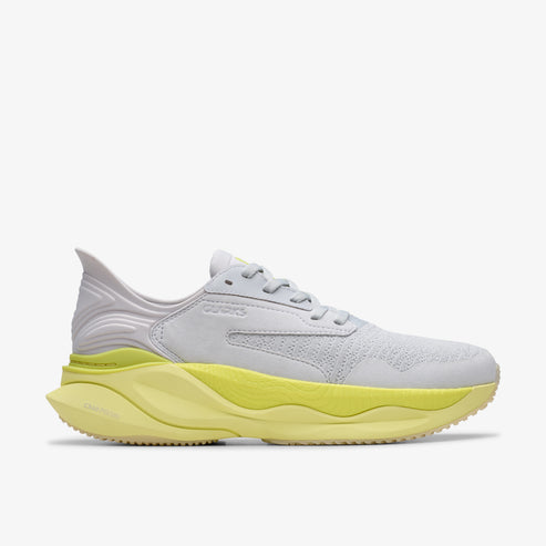 Gray and light yellow running shoe, with laces and a thick sole.