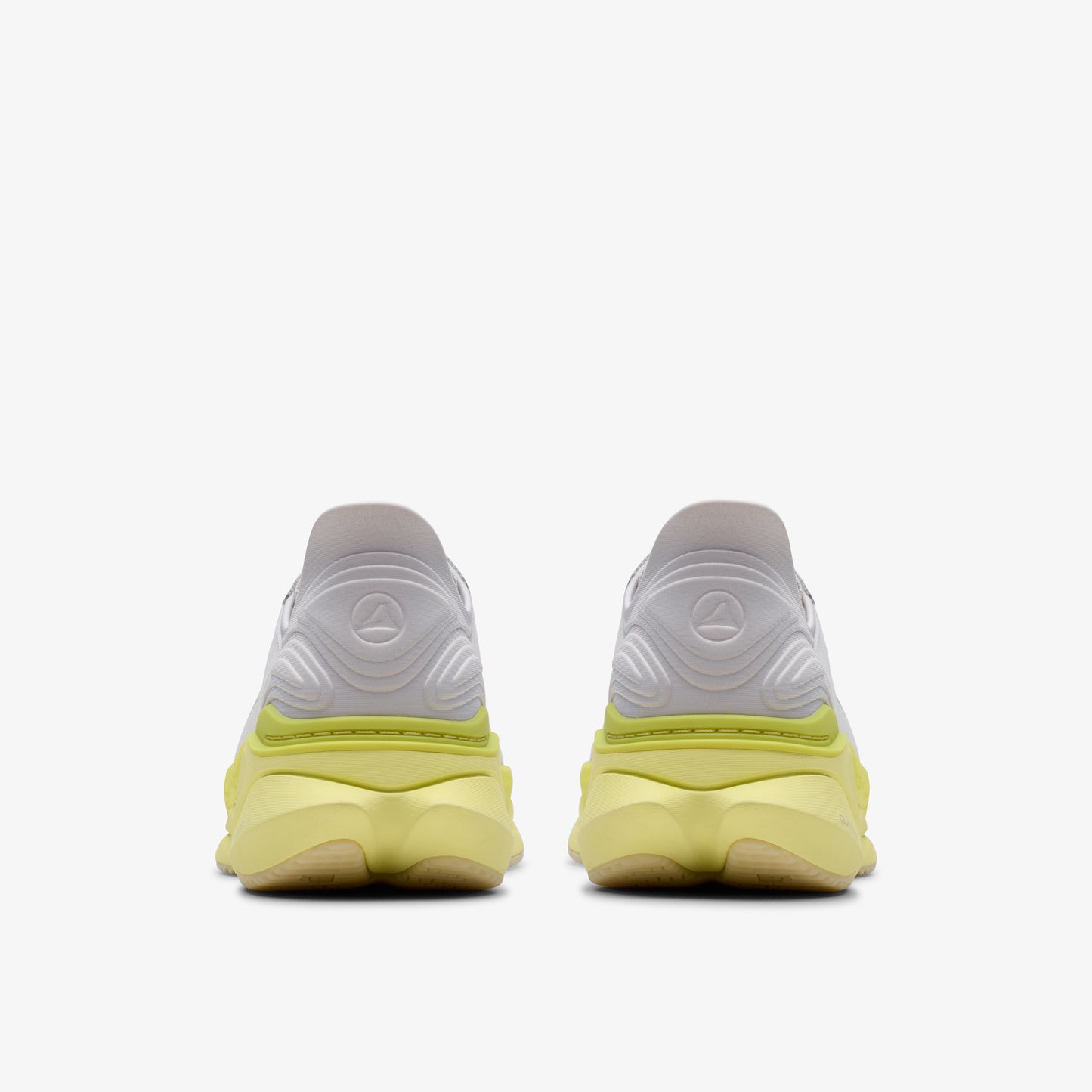 Rear view of white and yellow sneakers.