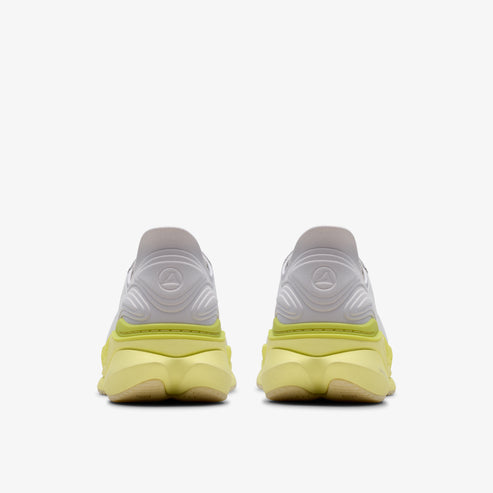 Rear view of white and yellow sneakers.