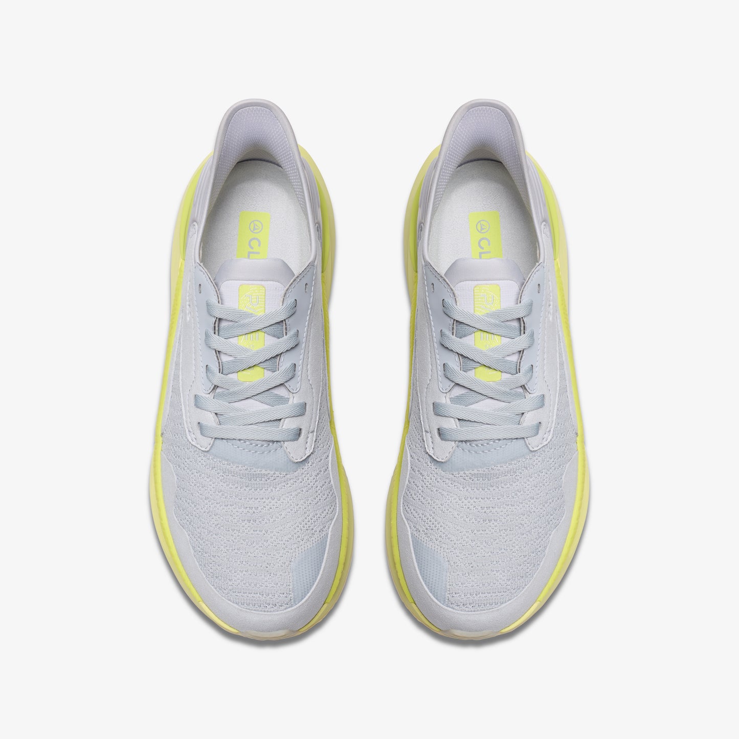 Top-down view of two light gray sneakers with light yellow soles and laces.