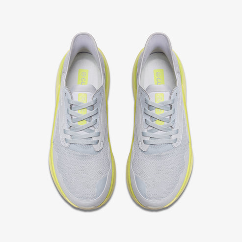 Top-down view of two light gray sneakers with light yellow soles and laces.