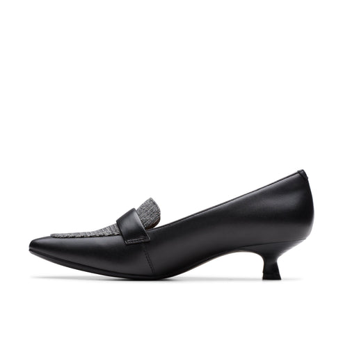 Black leather loafer pump with a pointed toe and a kitten heel.