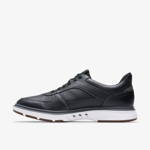 Side view of a black leather casual shoe with white sole and black laces.