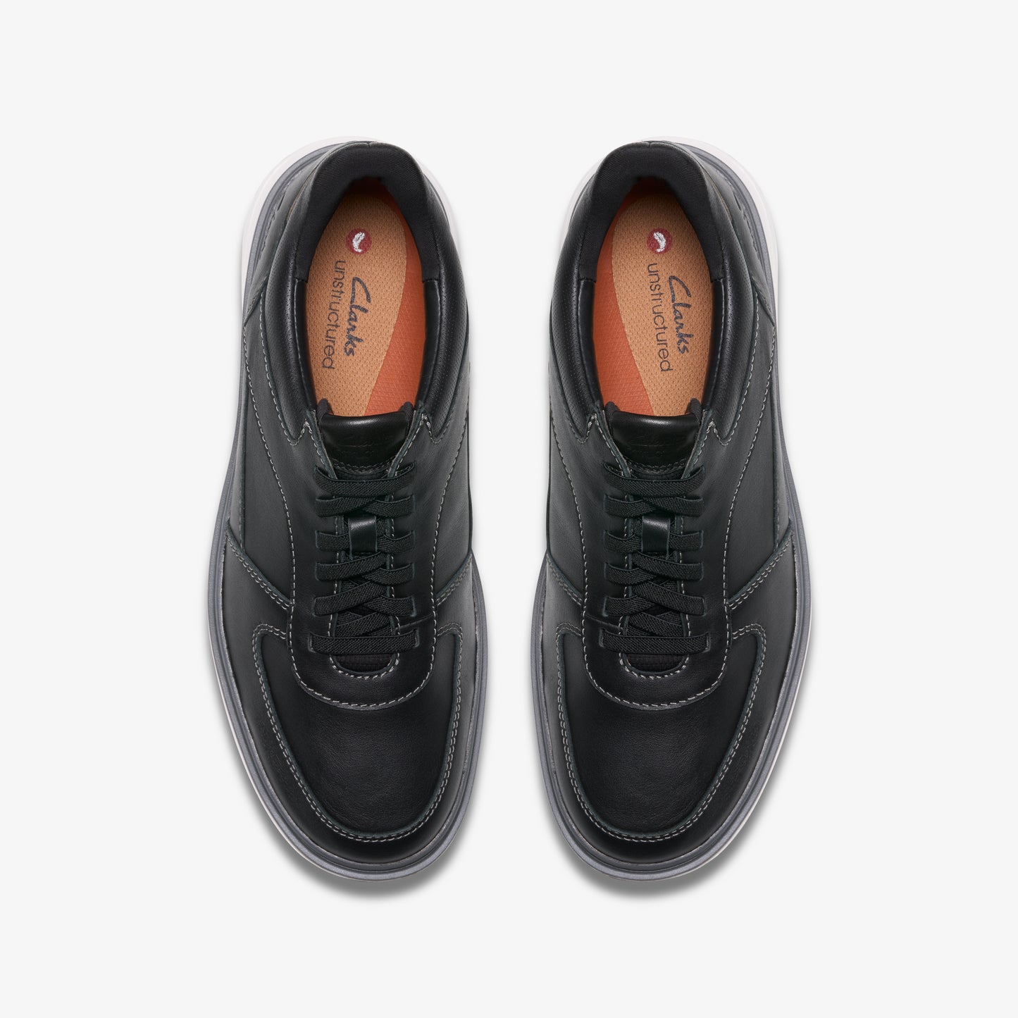 A pair of black leather lace-up sneakers with visible white stitching and a light grey sole.