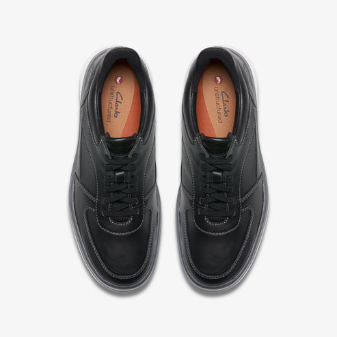 A pair of black leather lace-up sneakers with visible white stitching and a light grey sole.