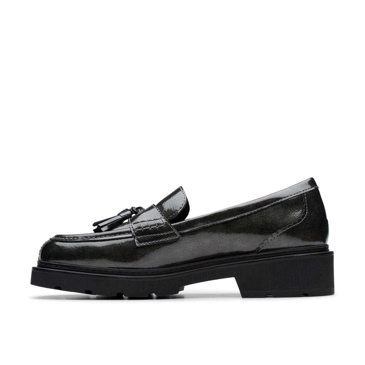 Black shiny loafer with black tassel and black sole, side view.