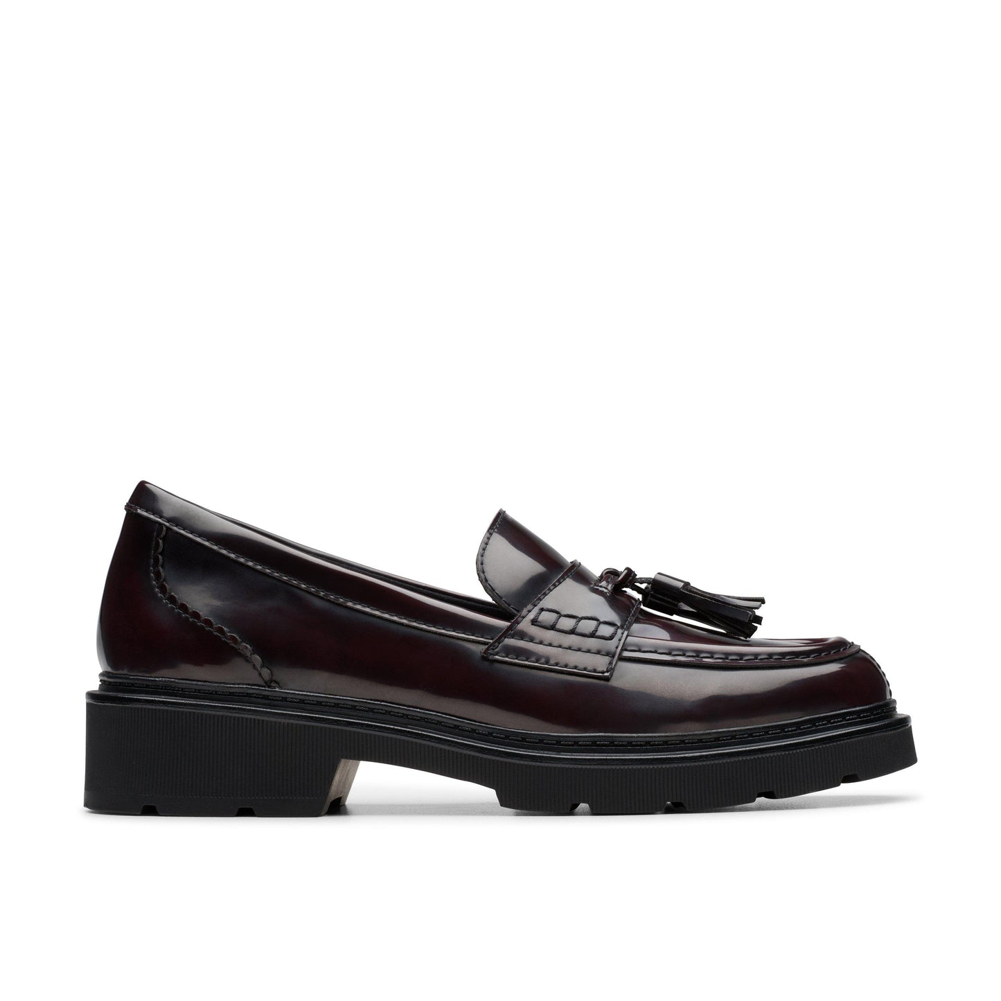 Oxblood leather penny loafer with a stacked heel and tassel embellishment.